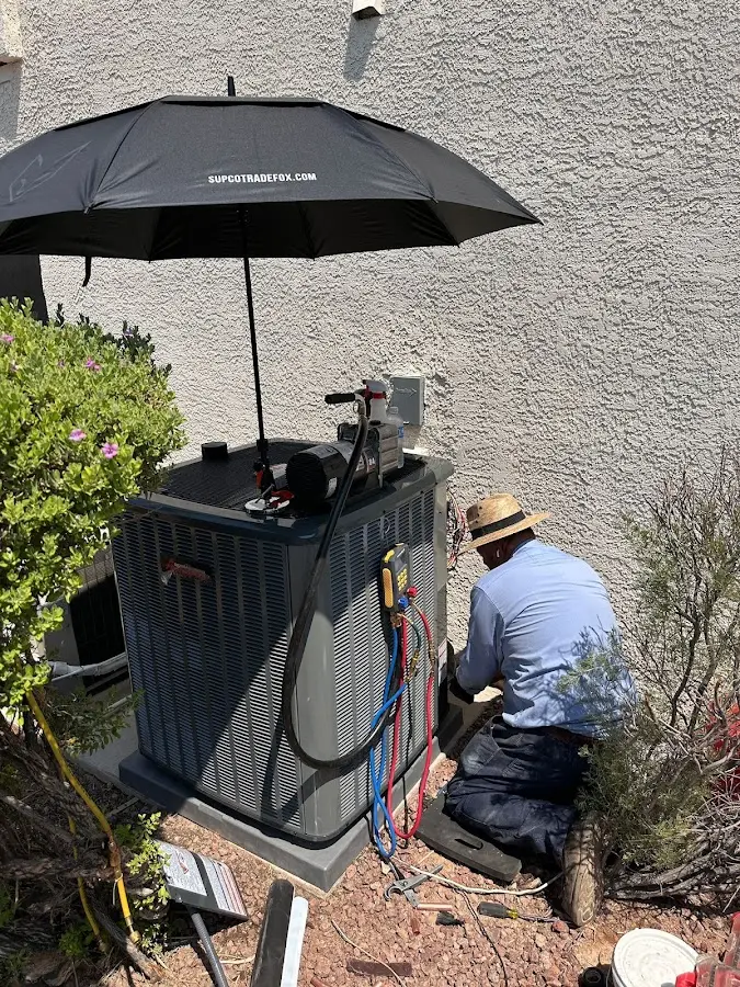 HVAC technician performing outdoor AC maintenance in Harwood Heights