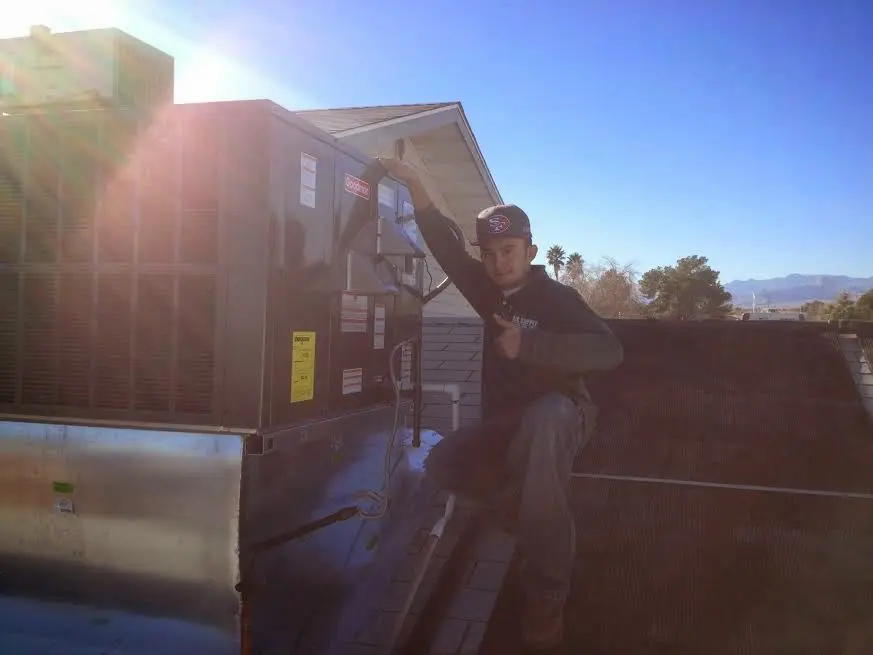HVAC technician performing HVAC Inspection on a rooftop unit in Harwood Heights
